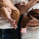 Parents holding young babies, close-up.