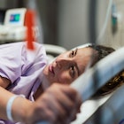 A pregnant woman in a hospital bed masturbating to induce labor.