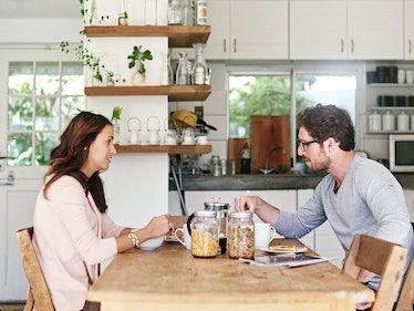 Couple at breakfast looking frustrated at one another