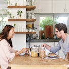 Couple at breakfast looking frustrated at one another