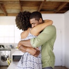Man and woman embracing in their home
