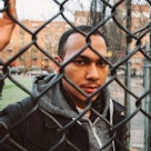 Coss Marte, behind a chain-link fence.