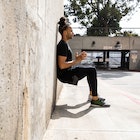 A man does a wall sit against a wall. Wall sits are the most effective isometric exercise for loweri...