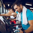 A man trying fasted cardio runs on a treadmill at the gym, on an empty stomach.