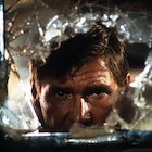 Harrison Ford looks through broken glass in a scene from the film 'Indiana Jones And The Temple Of D...