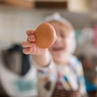 a baby holding an egg