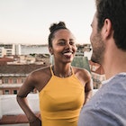 A woman flirting with a divorced man on a rooftop.