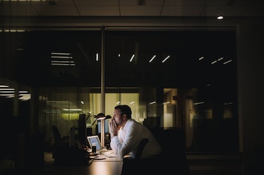 Stressed man working at office late at night 