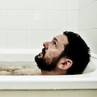 A man takes a post-workout ice bath.