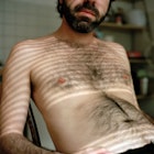 Shirtless man with a hairy chest.